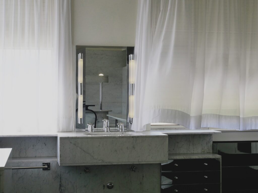 White breezy curtains over sink